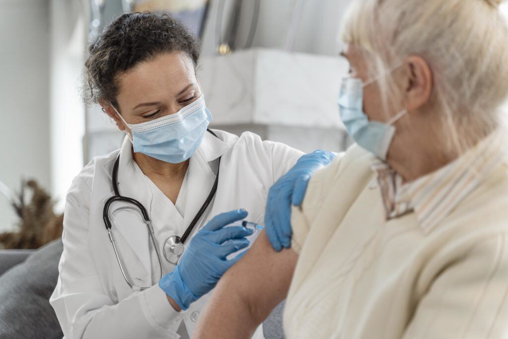 doctor-vaccinating-senior-woman-1024x683